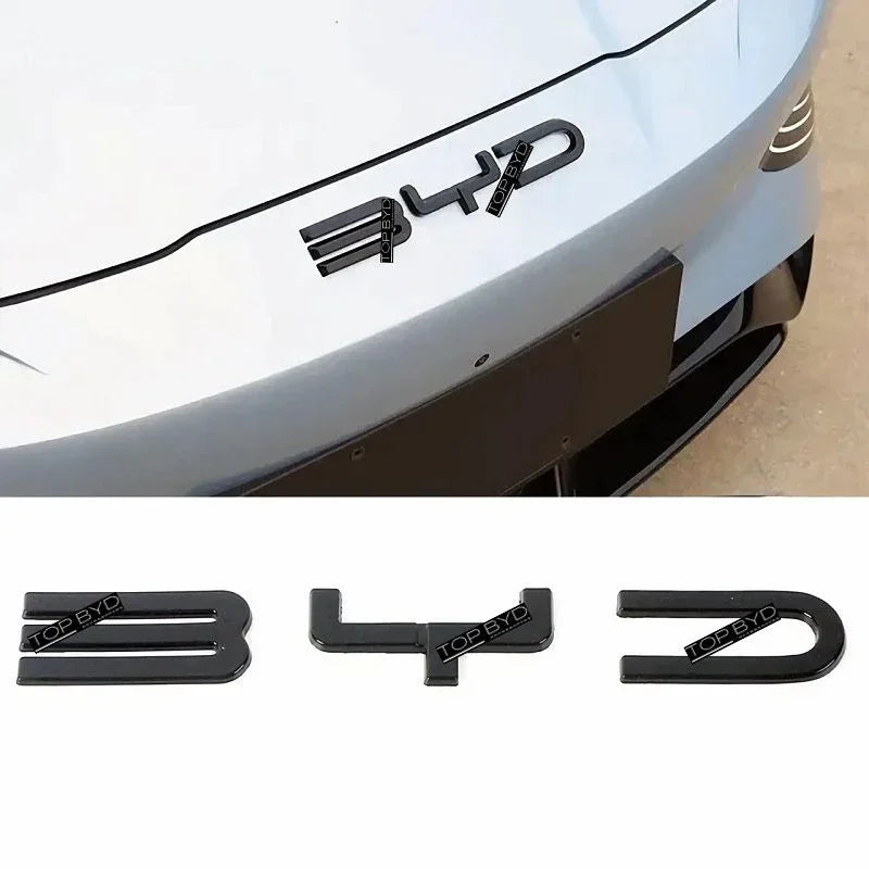 Gloss-black front badge cover fitted to a white BYD SEAL