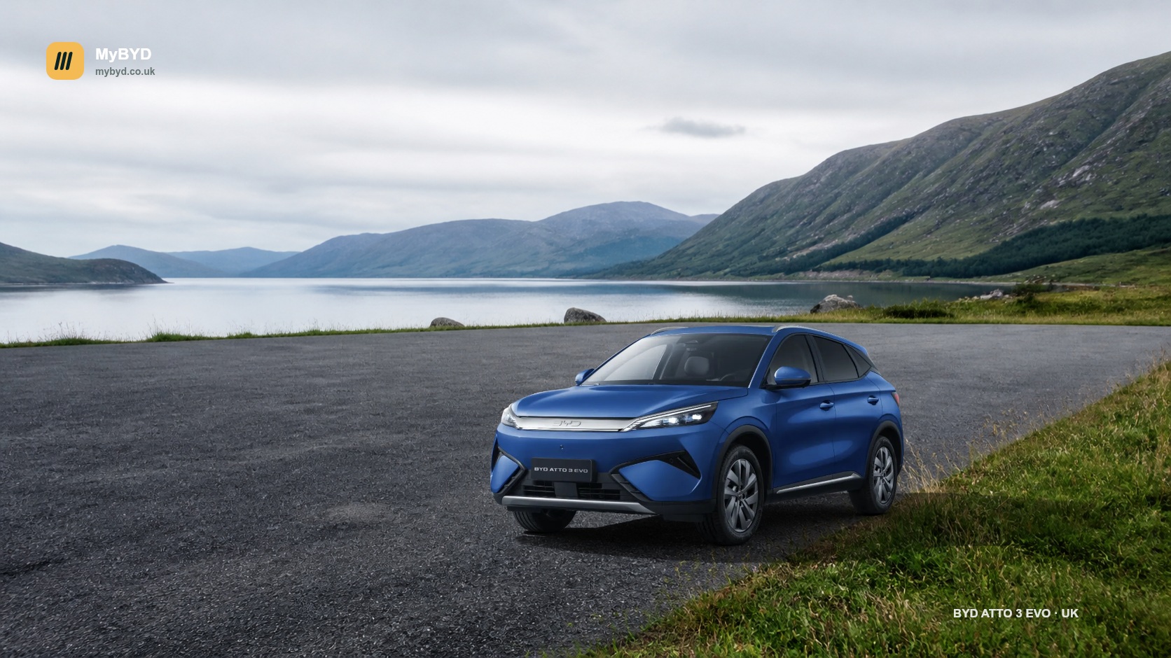 MyBYD desktop wallpaper featuring the current UK BYD ATTO 3 EVO beside a Scottish loch